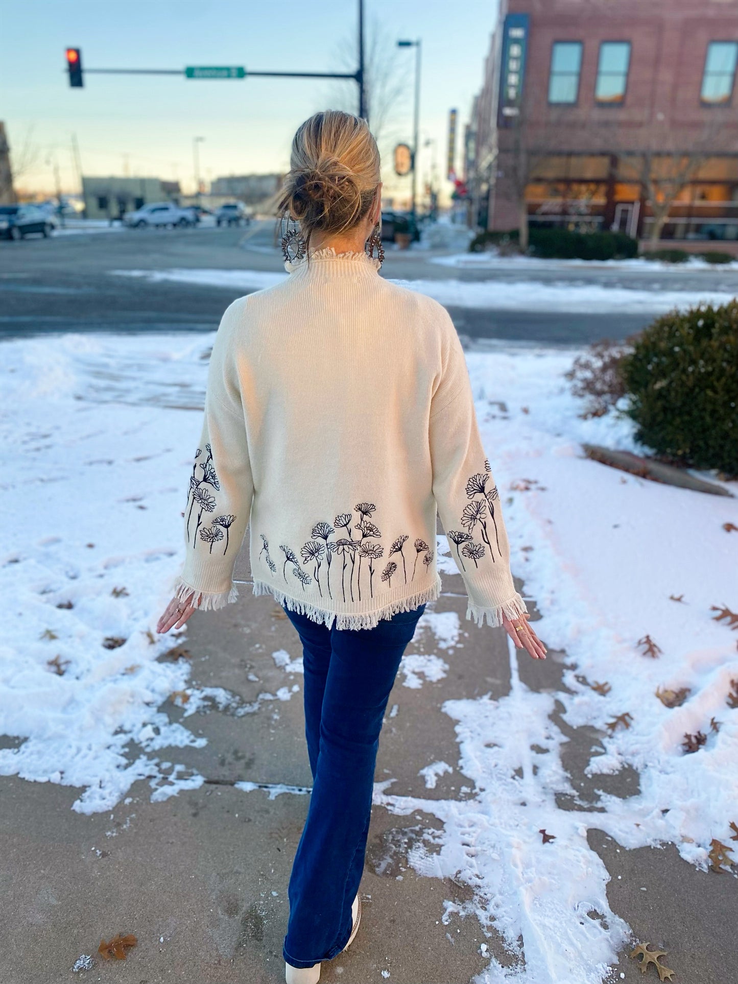 cream sweater with black embroidered flowers