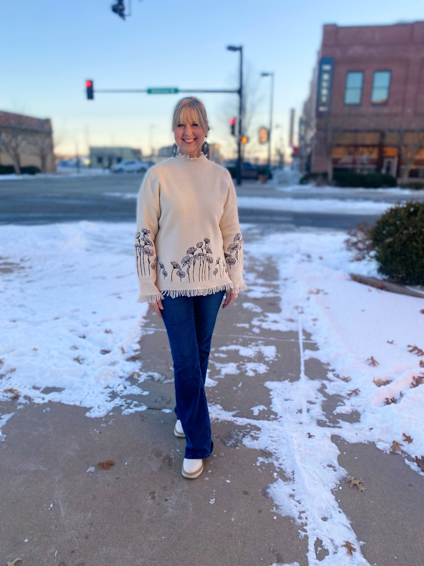 cream sweater with black embroidered flowers